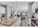 Open kitchen design with granite counters, white cabinets, and stainless steel appliances at 329 Lake Mist Ct., Longs, SC 29568