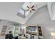 Living room with vaulted ceiling, large entertainment center, and coastal decor at 329 Lake Mist Ct., Longs, SC 29568