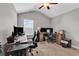 Spacious home office with vaulted ceiling features multiple computer monitors and desks for productivity at 329 Lake Mist Ct., Longs, SC 29568