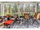 Inviting screened-in patio with comfortable seating, ceiling fan, and view of the backyard at 329 Lake Mist Ct., Longs, SC 29568