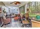 Charming screened-in patio with comfortable furniture, ceiling fan, and serene backyard view for relaxation at 329 Lake Mist Ct., Longs, SC 29568