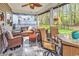 Inviting screened patio with cozy furniture, overhead fan and backyard views, creating a perfect outdoor retreat at 329 Lake Mist Ct., Longs, SC 29568