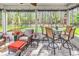 Relaxing screened-in patio with comfortable seating and a peaceful view of the private backyard at 329 Lake Mist Ct., Longs, SC 29568