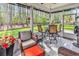 Inviting screened porch with a dining set, comfortable seating, and a tranquil view of the wooded backyard at 329 Lake Mist Ct., Longs, SC 29568