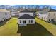 Aerial view of a well-maintained backyard of a modern two-story home featuring a sunroom at 4032 Bayhill St., Myrtle Beach, SC 29579