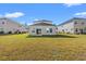 Expansive backyard featuring a well-maintained lawn with views of the rear of the bright modern home at 4032 Bayhill St., Myrtle Beach, SC 29579