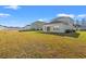 Expansive backyard featuring a well-maintained lawn and the rear of a bright, modern home with a sunroom at 4032 Bayhill St., Myrtle Beach, SC 29579