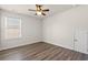 Bedroom with hardwood floors, ceiling fan, natural light from a window, and neutral walls at 4032 Bayhill St., Myrtle Beach, SC 29579