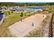 Aerial view of the community pool featuring lounge chairs, a sand volleyball court, and manicured landscaping at 4032 Bayhill St., Myrtle Beach, SC 29579
