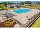 Aerial view of the community pool featuring ample lounge chairs, umbrellas, and a secure fenced perimeter at 4032 Bayhill St., Myrtle Beach, SC 29579