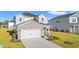 Charming two-story home featuring a stone accent wall, an attached two-car garage and a manicured lawn at 4032 Bayhill St., Myrtle Beach, SC 29579