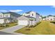 Charming two-story home featuring a stone accent wall, an attached two-car garage and a manicured lawn at 4032 Bayhill St., Myrtle Beach, SC 29579