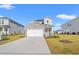 Charming two-story home featuring a stone accent wall, an attached two-car garage and a manicured lawn at 4032 Bayhill St., Myrtle Beach, SC 29579
