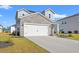 Charming two-story home featuring a stone accent wall, an attached two-car garage and a manicured lawn at 4032 Bayhill St., Myrtle Beach, SC 29579