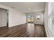 Bright and airy living room features a sliding glass door, hardwood floors, and neutral paint at 4032 Bayhill St., Myrtle Beach, SC 29579