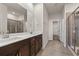 Main bathroom featuring double sinks, tiled floors, and a glass-enclosed shower at 4032 Bayhill St., Myrtle Beach, SC 29579