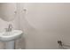 Compact powder room with stylish pedestal sink and round mirror at 4032 Bayhill St., Myrtle Beach, SC 29579
