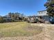 Large backyard with a wooden deck, steps to the house, and serene water views at 613 23Rd Ave. N, North Myrtle Beach, SC 29582