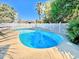 Refreshing backyard swimming pool surrounded by a white picket fence and lush greenery at 613 23Rd Ave. N, North Myrtle Beach, SC 29582