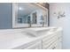 Bright bathroom featuring double sinks with square basins and a large framed mirror at 707 S Ocean Blvd. # 602, North Myrtle Beach, SC 29582
