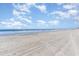 A picturesque beach view with blue skies, fluffy clouds, and ocean waves at 707 S Ocean Blvd. # 602, North Myrtle Beach, SC 29582