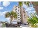 Low angle of condominium complex featuring palm trees and parking at 707 S Ocean Blvd. # 602, North Myrtle Beach, SC 29582