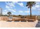 Community beachfront deck featuring palm trees, lounge chairs and easy beach access at 707 S Ocean Blvd. # 602, North Myrtle Beach, SC 29582