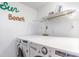 Laundry room with stacked washer and dryer and shelving at 707 S Ocean Blvd. # 602, North Myrtle Beach, SC 29582
