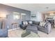 Comfortable living room with stylish gray furnishings and an adjacent dining area and kitchen at 707 S Ocean Blvd. # 602, North Myrtle Beach, SC 29582