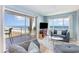Living room with comfortable seating and access to a balcony that overlooks the ocean at 707 S Ocean Blvd. # 602, North Myrtle Beach, SC 29582