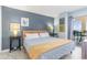 Comfortable main bedroom with a queen bed and a sliding glass door to balcony with ocean view at 707 S Ocean Blvd. # 602, North Myrtle Beach, SC 29582