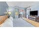 Comfortable main bedroom with television and sliding glass door to balcony with ocean view at 707 S Ocean Blvd. # 602, North Myrtle Beach, SC 29582