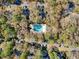 Aerial view of a community pool surrounded by mature trees and parked vehicles at 95 Weehawka Way # 2, Pawleys Island, SC 29585