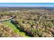 Picturesque aerial view of a golf course featuring a winding lake and lush trees at 95 Weehawka Way # 2, Pawleys Island, SC 29585