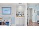 Compact dry bar area with sink, counter space, storage cabinets and decorative tiling at 95 Weehawka Way # 2, Pawleys Island, SC 29585