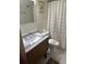 Well-maintained bathroom with a tiled floor, wooden vanity, and tub with shower at 95 Weehawka Way # 2, Pawleys Island, SC 29585