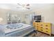 Comfortable bedroom with a large window showcasing the outside view and a wooden dresser at 95 Weehawka Way # 2, Pawleys Island, SC 29585