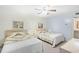 Bright bedroom with twin beds, ceiling fan, and side table with lamp at 95 Weehawka Way # 2, Pawleys Island, SC 29585