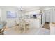 Cozy dining area with table, chandelier, and access to a modern kitchen at 95 Weehawka Way # 2, Pawleys Island, SC 29585
