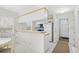 Bright kitchen featuring white appliances, a breakfast bar, and an eat-in dining area at 95 Weehawka Way # 2, Pawleys Island, SC 29585