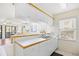 Kitchen featuring white cabinets, counter space, and an open view to the living area at 95 Weehawka Way # 2, Pawleys Island, SC 29585