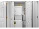 Laundry closet with stackable washer/dryer and water heater at 95 Weehawka Way # 2, Pawleys Island, SC 29585