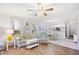 Bright living room with hardwood floors, ceiling fan, and open view to the kitchen at 95 Weehawka Way # 2, Pawleys Island, SC 29585
