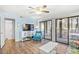 Bright living room with hardwood floors, blue accent wall, and sliding glass doors to the outside at 95 Weehawka Way # 2, Pawleys Island, SC 29585