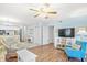 Bright living room with ceiling fan, hardwood floors, open to kitchen and dining area at 95 Weehawka Way # 2, Pawleys Island, SC 29585