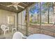 Enclosed porch with patio furniture offering views of the manicured backyard at 95 Weehawka Way # 2, Pawleys Island, SC 29585