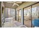 Spacious screened porch with table and ceiling fan, flowing into an interior living space at 95 Weehawka Way # 2, Pawleys Island, SC 29585