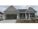 New single-story home featuring a two-car garage, covered entry and simple landscaping at 997 Oak Hollow St., Longs, SC 29568