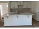 Bright kitchen features a center island with a sink and white cabinets at 997 Oak Hollow St., Longs, SC 29568