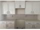 The kitchen showcases modern white cabinets and a gray backsplash at 997 Oak Hollow St., Longs, SC 29568
